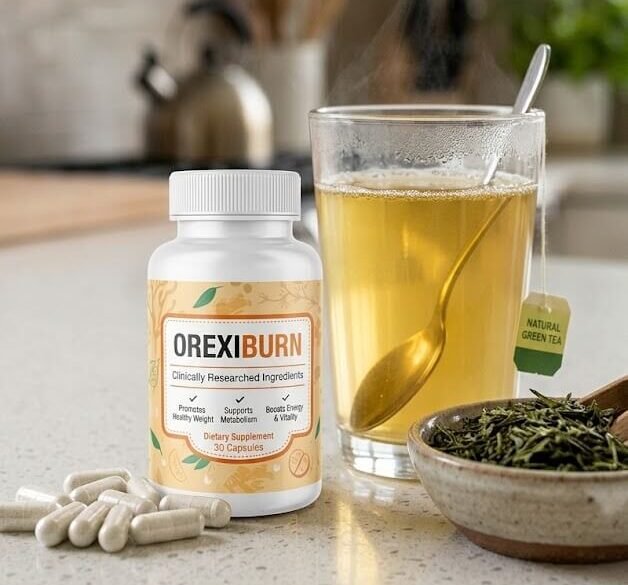 Green tea extract capsules next to loose green tea leaves and a glass of brewed green tea, on a clean kitchen counte